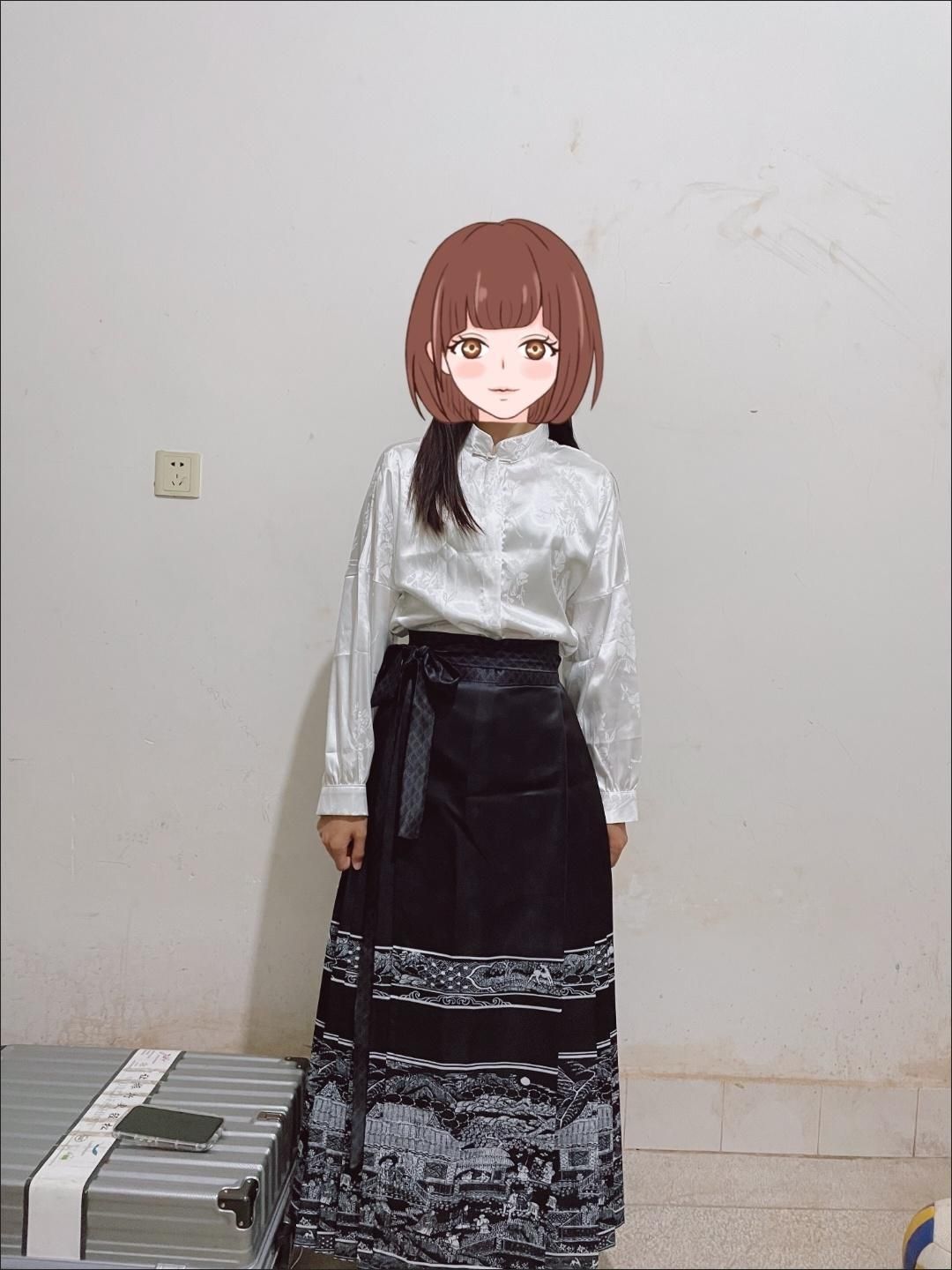 Woman wearing a traditional Hanfu outfit featuring a black skirt with intricate designs and a white blouse.