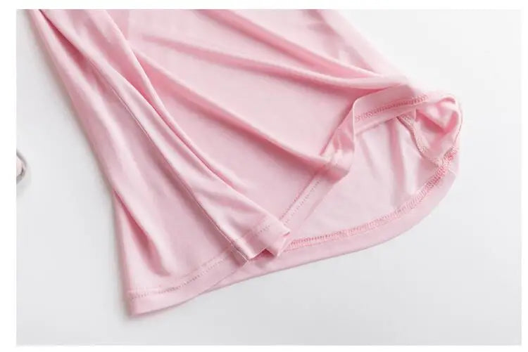 Close-up of lightweight pink silk cami fabric, highlighting smooth texture and delicate stitching details.