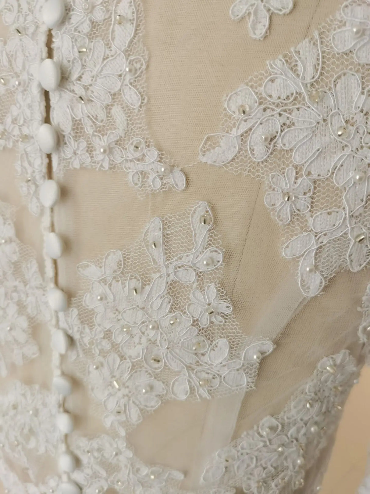 Close-up of intricate lace and pearl details on a Crystal Lace Wedding Bolero bridal wrap.
