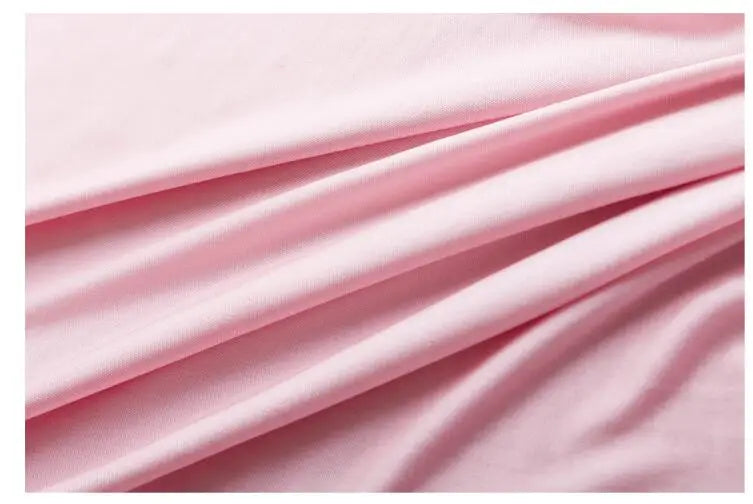 Close-up of soft pink mulberry silk fabric, highlighting its smooth texture and elegant drape for stylish apparel.