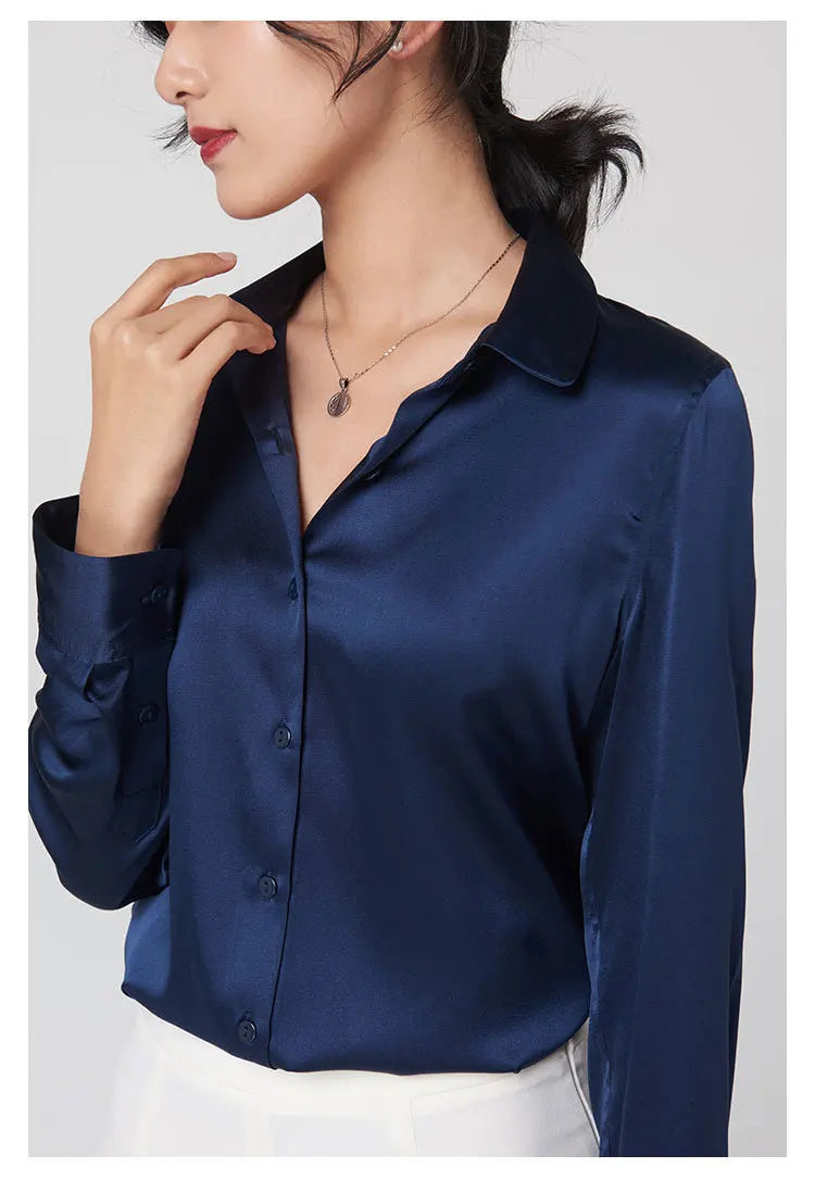 Model wearing a navy blue satin long sleeve silk shirt with a V-neck collar, showcasing premium Mulberry silk fabric.