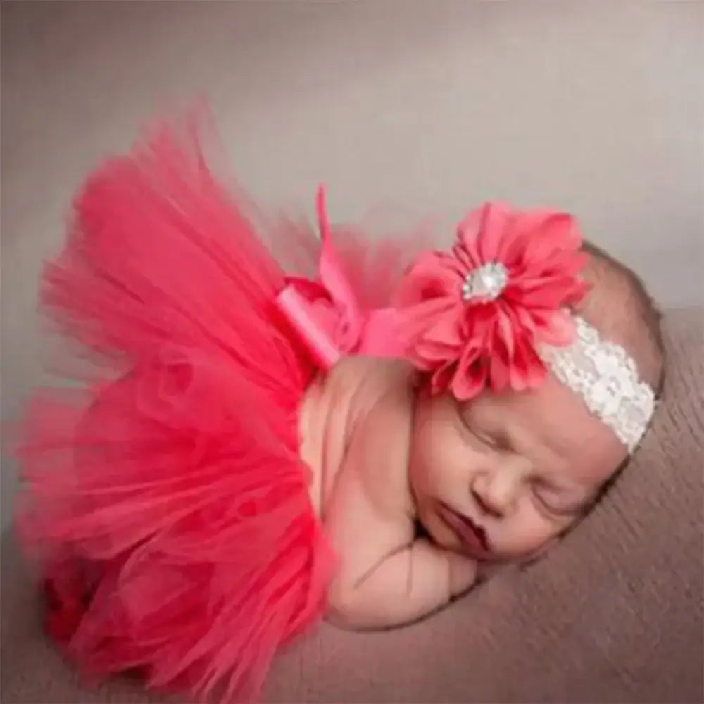 Sleeping baby girl in pink tutu skirt and headband set, perfect for photo shoots and newborn photography.