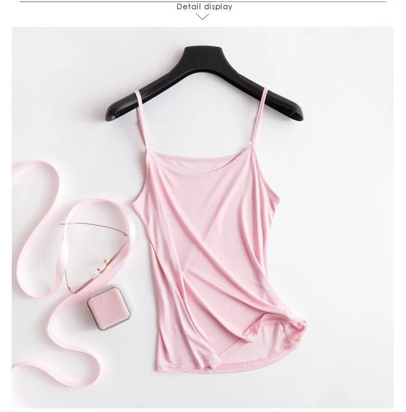 Lightweight pink U-neck silk cami with solid straps displayed on hanger, ideal for summer wear.