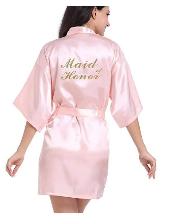 Light pink satin bridesmaid robe with gold 'Maid of Honor' text for elegant weddings.