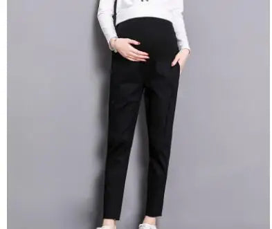 Casual black maternity pants on a model, featuring pockets and a straight fit, suitable for all seasons.