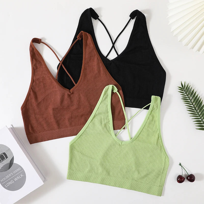 Three seamless crop tops in black, brown, and green, featuring a stylish, sexy design for women's streetwear fashion.
