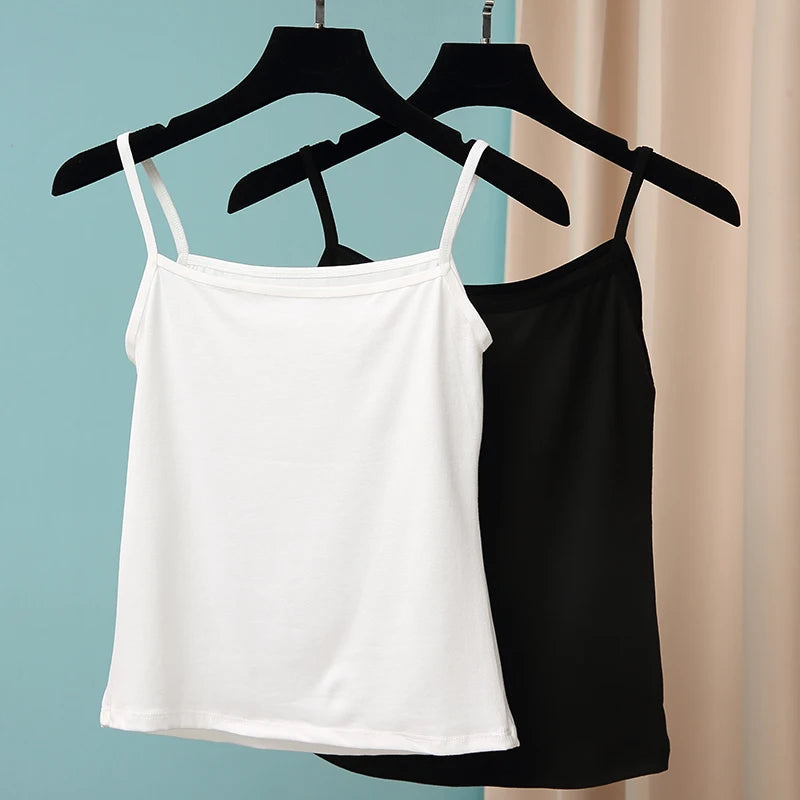 BasicBreeze™ solid cotton strap camis in white and black hanging on display, perfect for everyday wear.