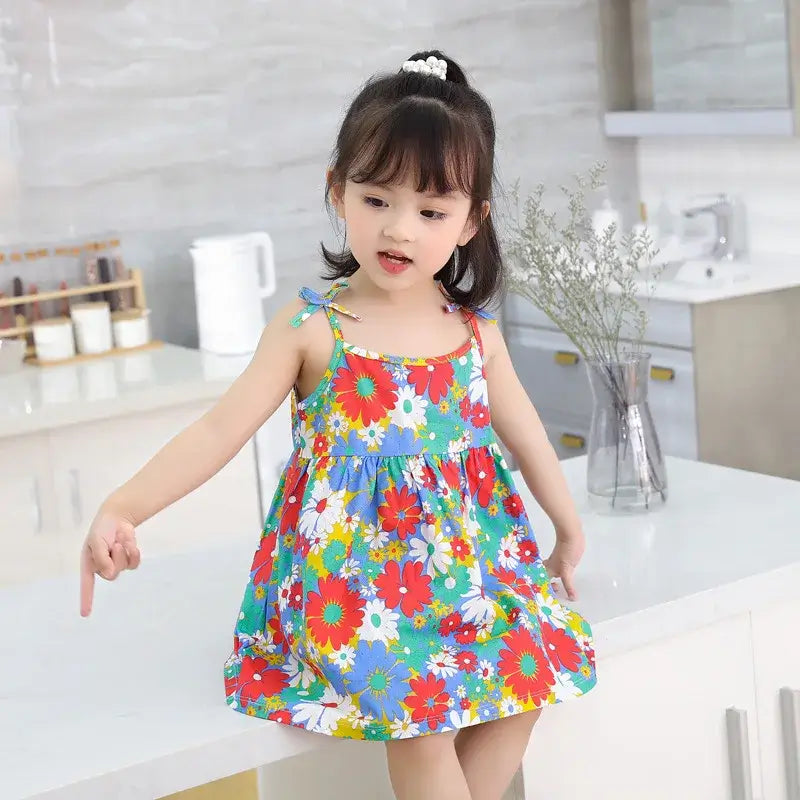 Adorable girl in a colorful floral summer dress, showcasing a playful style and bright patterns, perfect for kids ages 4-6.