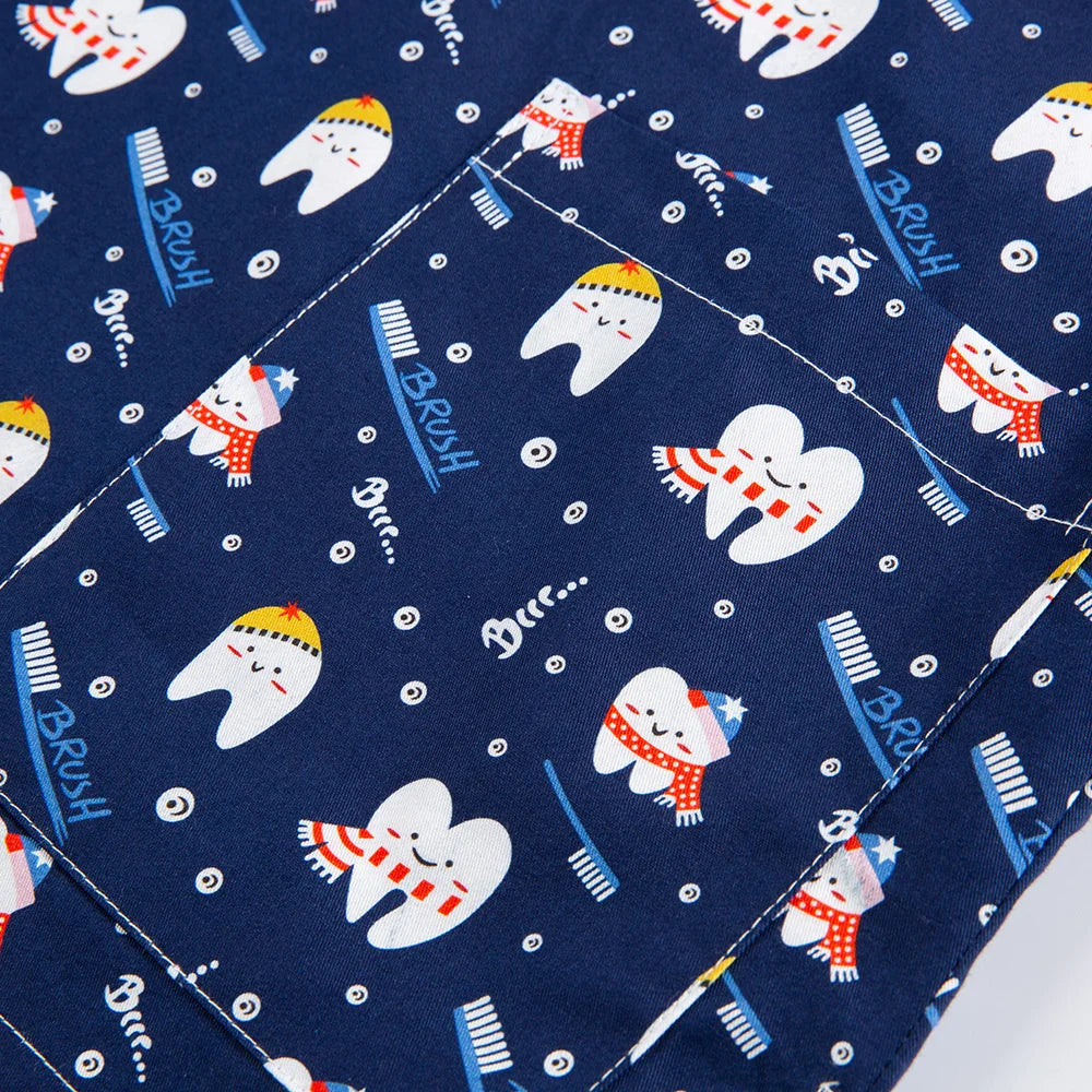Patterned fabric featuring playful teeth and toothbrushes on a navy background for nurse scrubs.