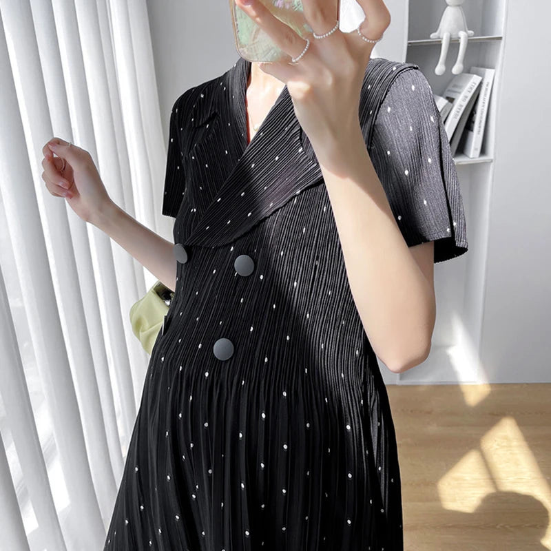 Polka dot Korean maternity dress in black, featuring a v-neck, short sleeves, and pleated design, perfect for summer wear.