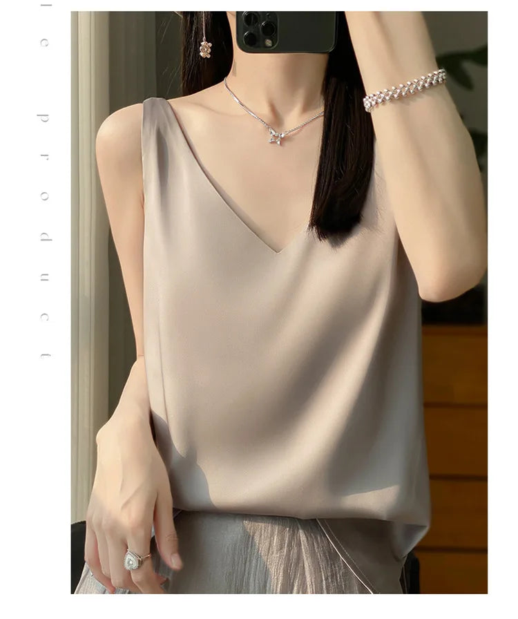 Woman wearing a v-neck ice silk camisole, showcasing the elegant design and summer comfort in a soft hue.