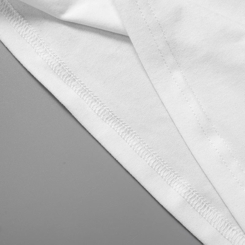 Close-up of the hem and stitch detailing on a white knitted camisole tank top.