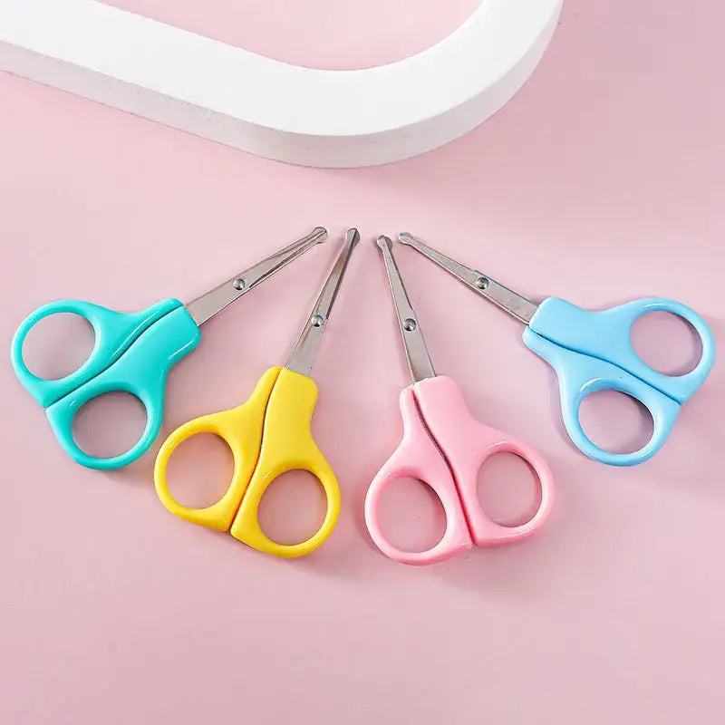 Colorful baby nail clippers in blue, pink, yellow, and green for newborn hygiene and care.