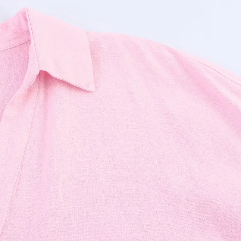 Close-up of pink turn-down collar fabric of a loose fit oversized shirt for women.