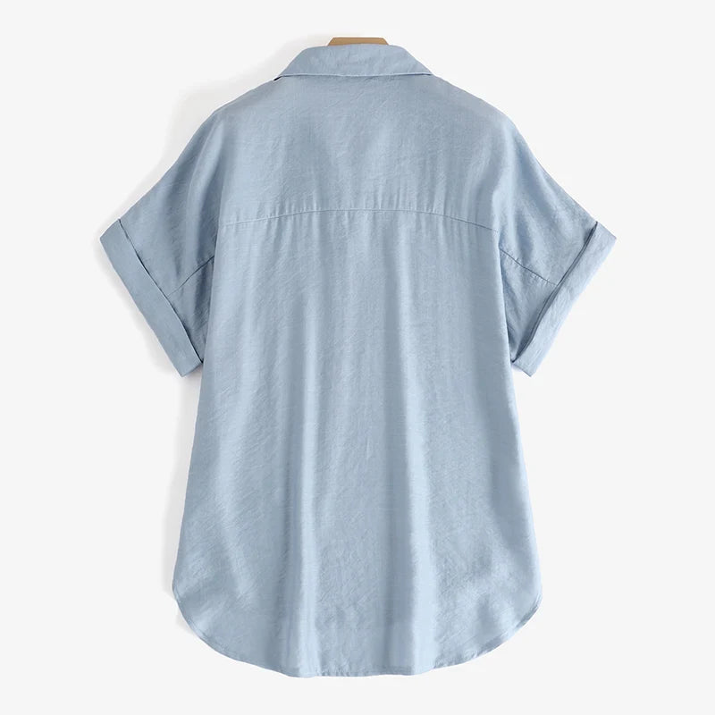Light blue oversized summer blouse with rolled sleeves and turn-down collar, perfect for a relaxed fit.