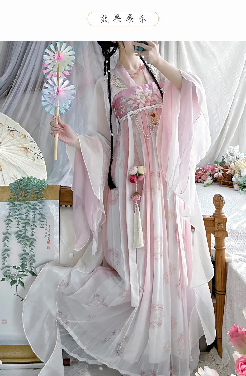 Women wearing a vintage Chinese style traditional Hanfu dress in soft pink with decorative details and a fan.