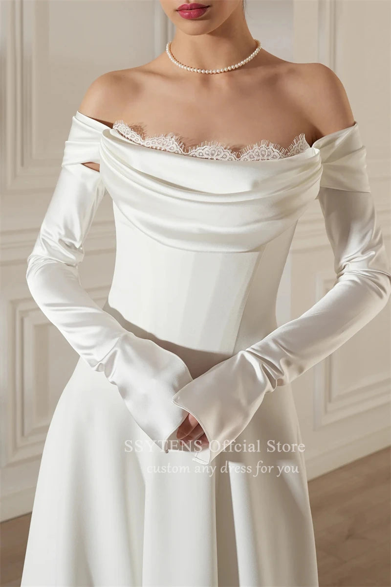Chic off-shoulder satin wedding dress with detachable sleeves and lace detail from SSYTENS.