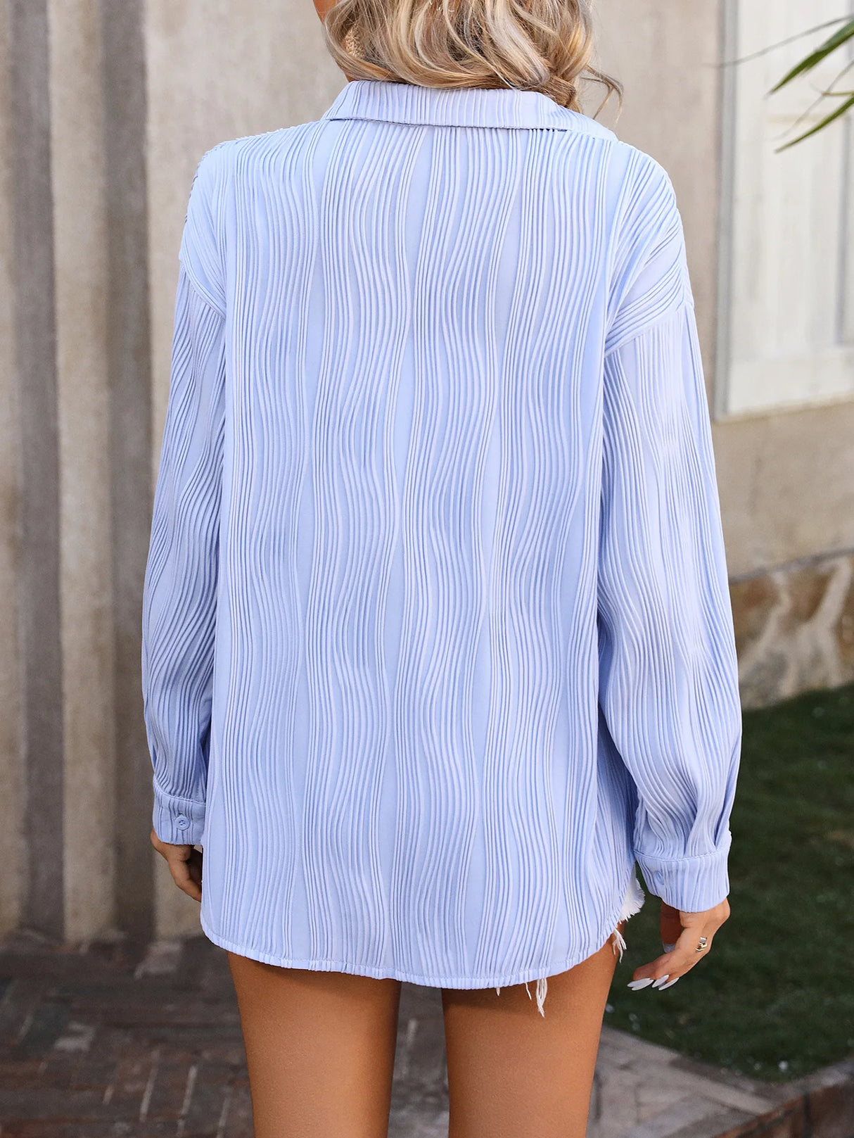 Back view of a loose-fit blue striped blouse for women, ideal for spring and autumn streetwear.