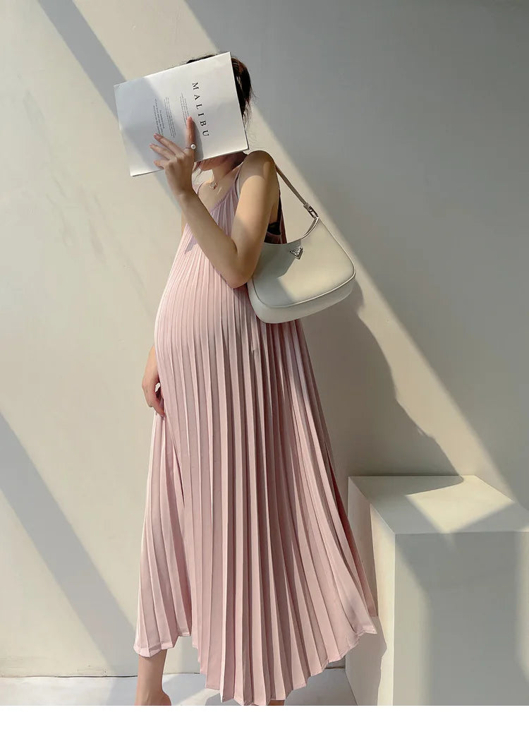 Pleated chiffon maternity dress in soft pink, showcasing a mid-calf length and stylish design, ideal for summer wear.