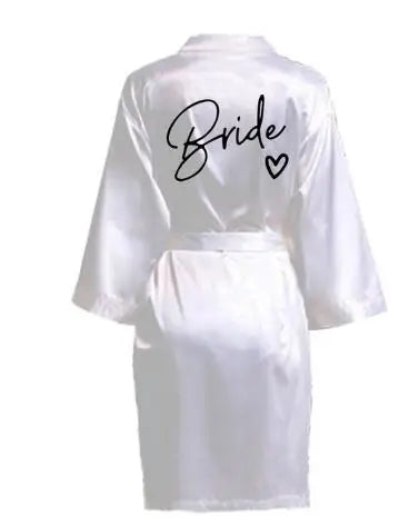 Back view of a white satin robe with 'Bride' printed in elegant black font, perfect for wedding celebrations.