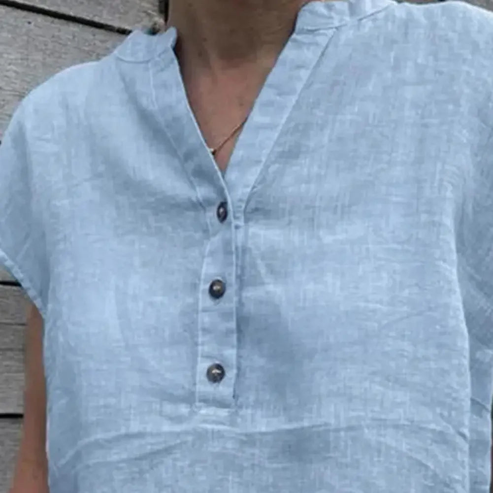 Close-up of a light blue cotton linen V-neck blouse featuring button closure and casual style, perfect for summer.