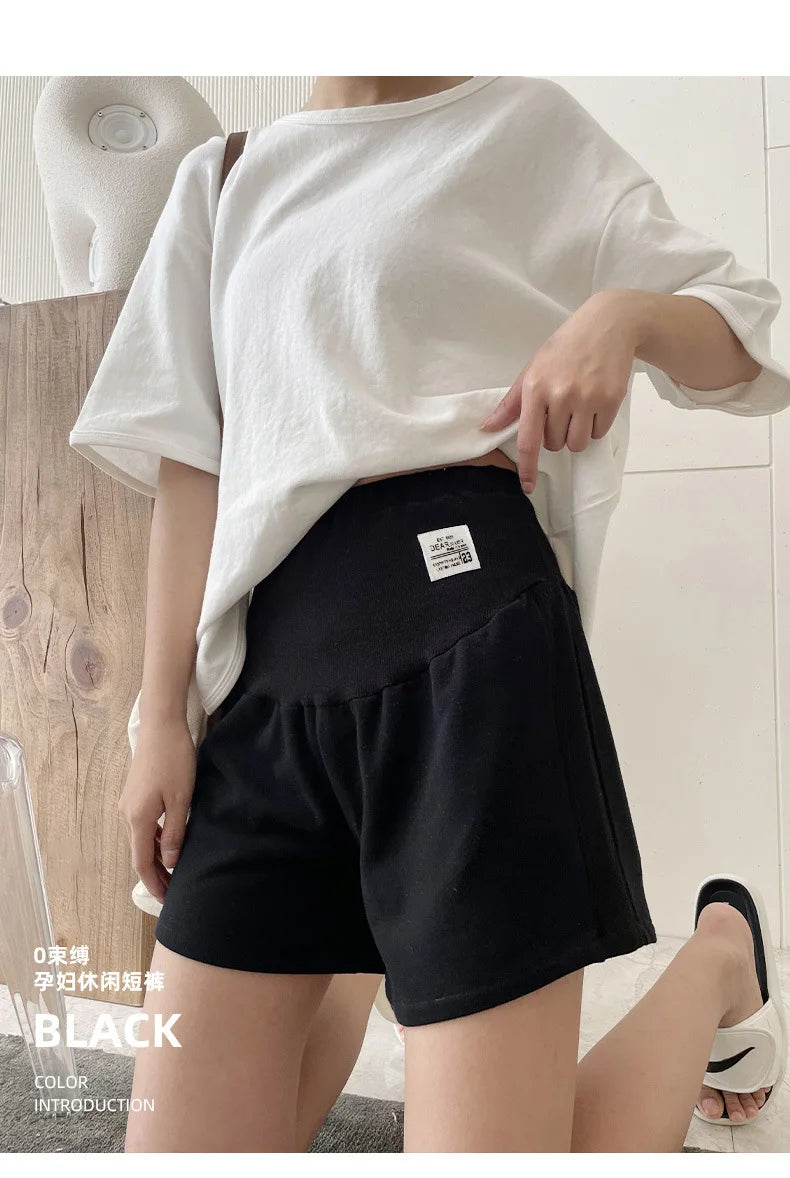 Plus size adjustable maternity shorts in black, featuring a loose fit and comfortable waistband, ideal for summer wear.