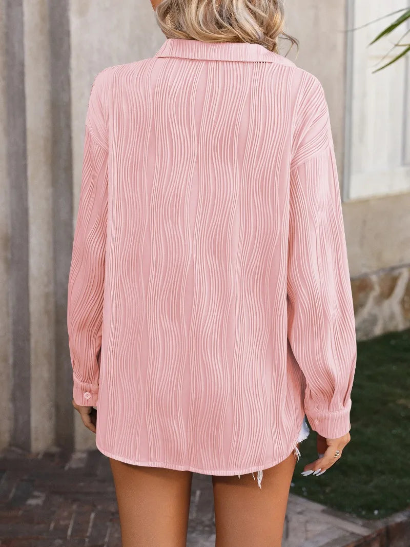 Back view of a loose-fitting pink casual blouse with a turn-down collar, featuring a textured design for women.