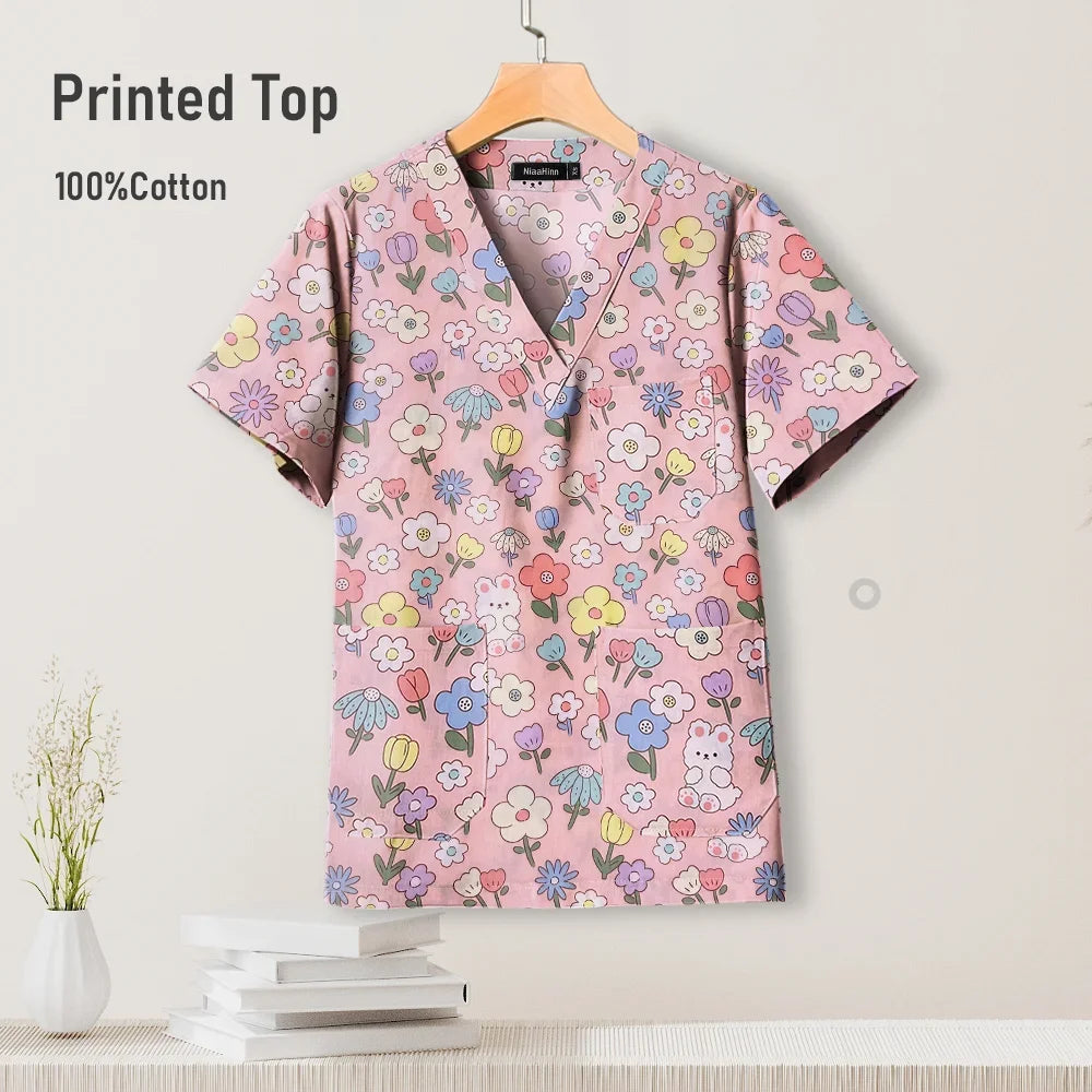 Colorful printed cotton scrub top featuring a floral design, suitable for pediatric nursing uniforms.