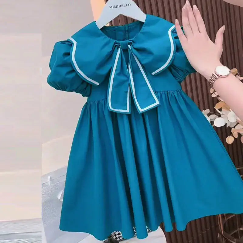 Cute summer blue dress for baby girls, featuring puff sleeves and a Peter Pan collar, knee-length design.