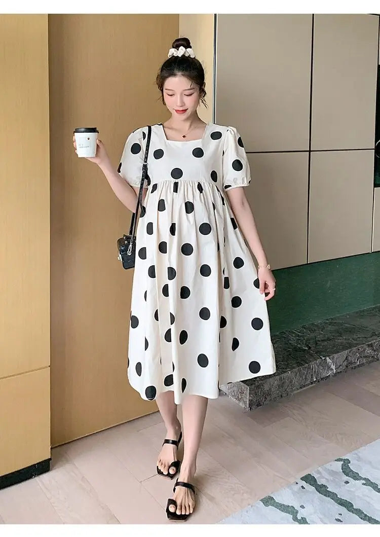 Polka dot loose maternity dress, mid-calf length, perfect for summer, made from cotton and polyester for comfort.