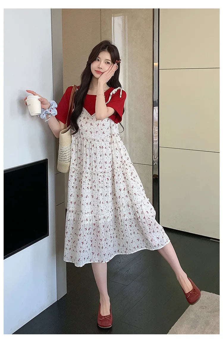 Model wearing a floral two-piece maternity skirt with contrasting colors in a modern indoor setting.