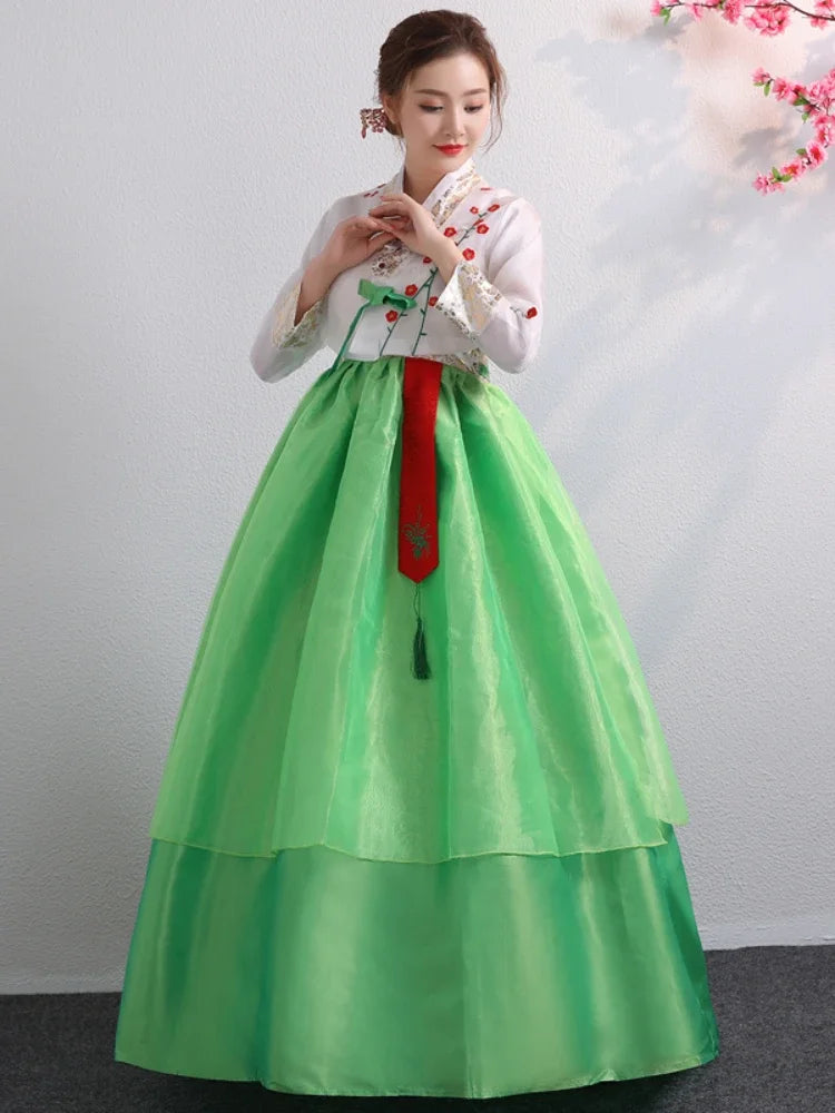 Traditional Korean Hanbok dress in green and white with intricate embroidery, perfect for cultural celebrations and dance.