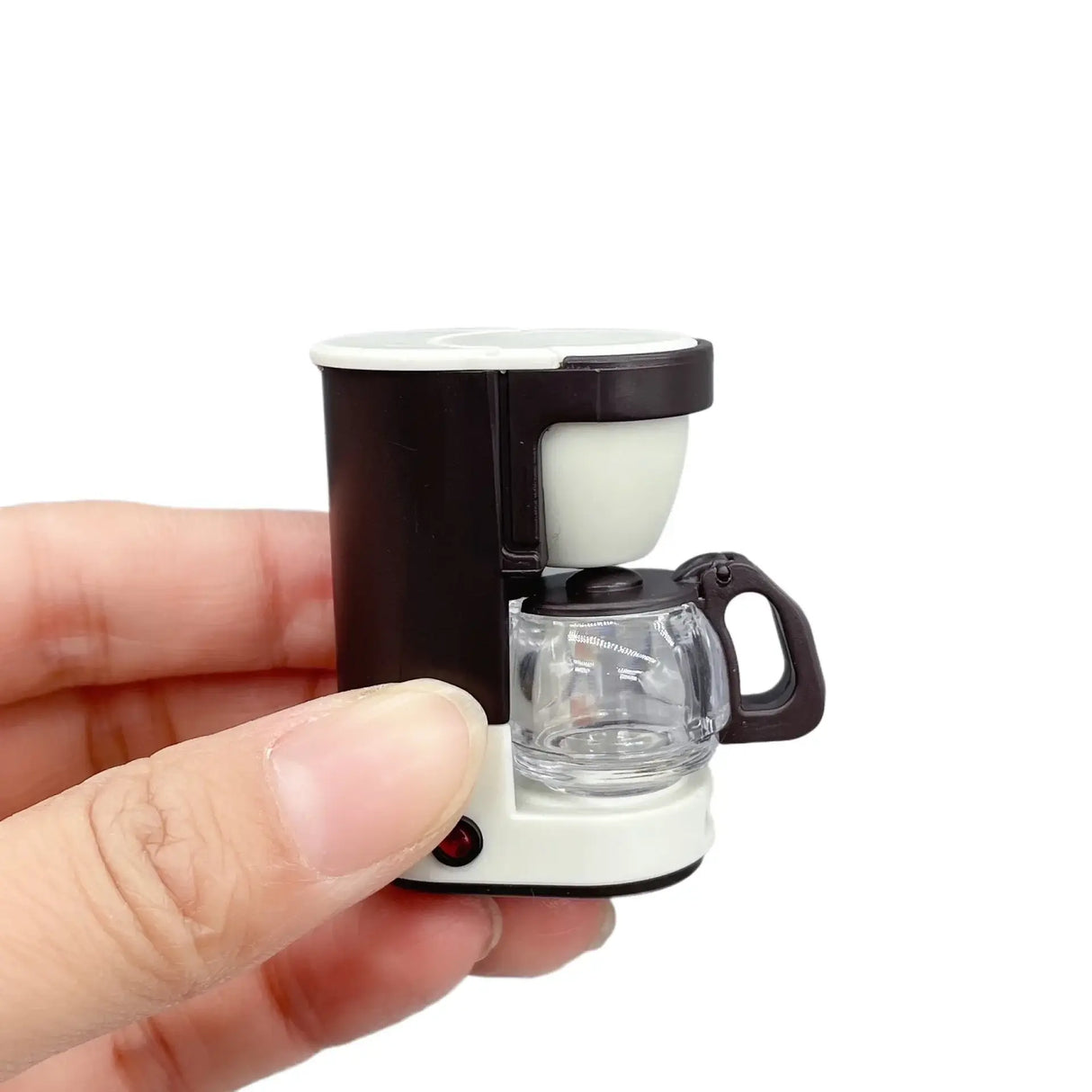 Miniature coffee maker prop held in hand, perfect for newborn baby photography setups with unisex design.