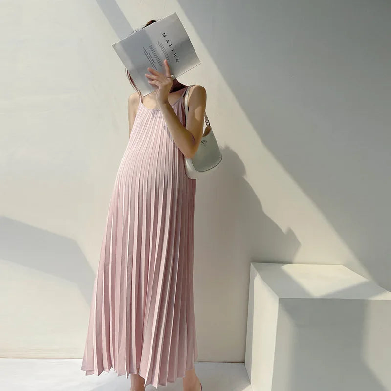 Pleated chiffon maternity dress in soft pink, perfect for summer, featuring a flowing mid-calf design.