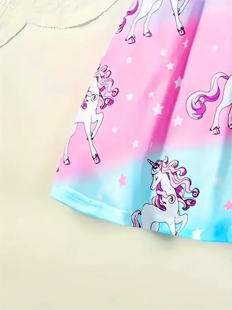 Knee-length unicorn dress for girls in vibrant pink and blue, featuring playful unicorn and star patterns.