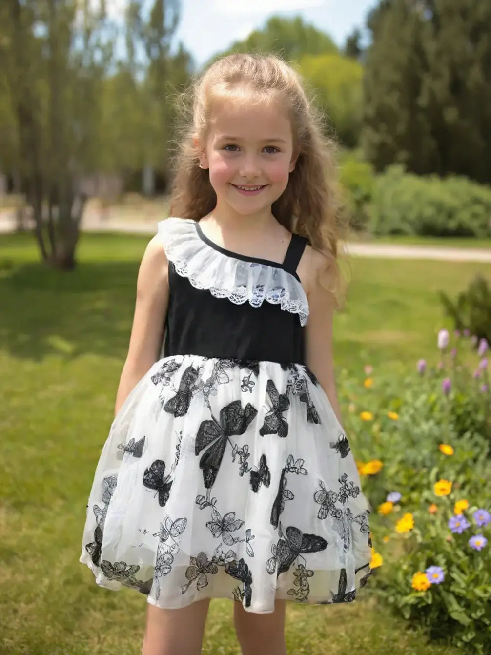 Toddler girl wearing a stylish butterfly print summer dress with lace details, perfect for ages 4-6 years.