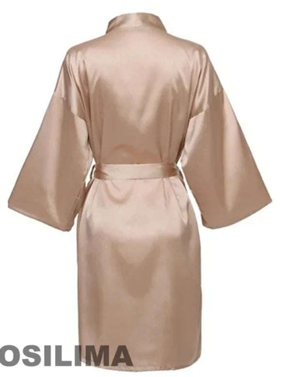 Back view of a silk satin kimono-style robe in beige, featuring wide sleeves and a belt.