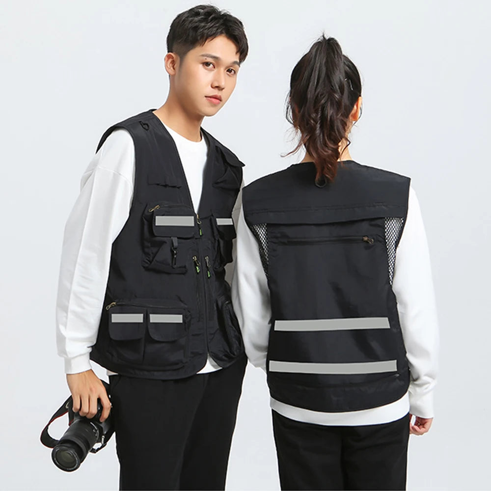 Two models wearing a black reflective vest with pockets and zippers, showcasing its utility and style in outdoor settings.