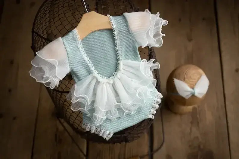 Soft cotton newborn photography outfit with ruffled sleeves and tutu design, perfect for capturing precious baby moments.