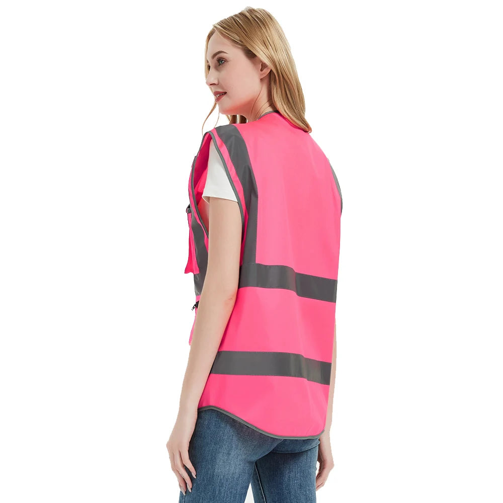 Women’s high visibility pink safety vest with reflective tape, ideal for construction and emergency work.