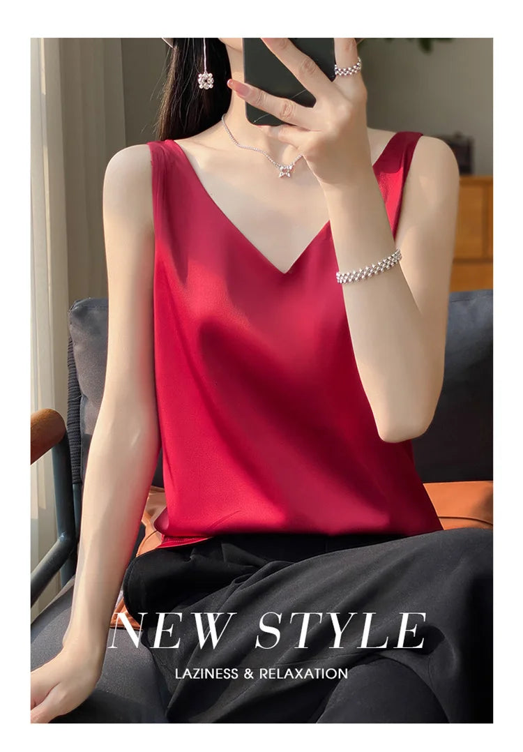 Model wearing a red V-neck satin camisole, showcasing summer style and relaxation in casual fashion.
