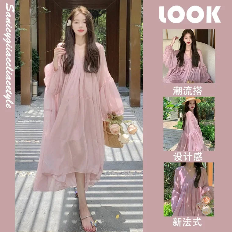 Model wearing a sweet strappy pink maternity dress, showcasing a flowy chiffon design for summer vacations.