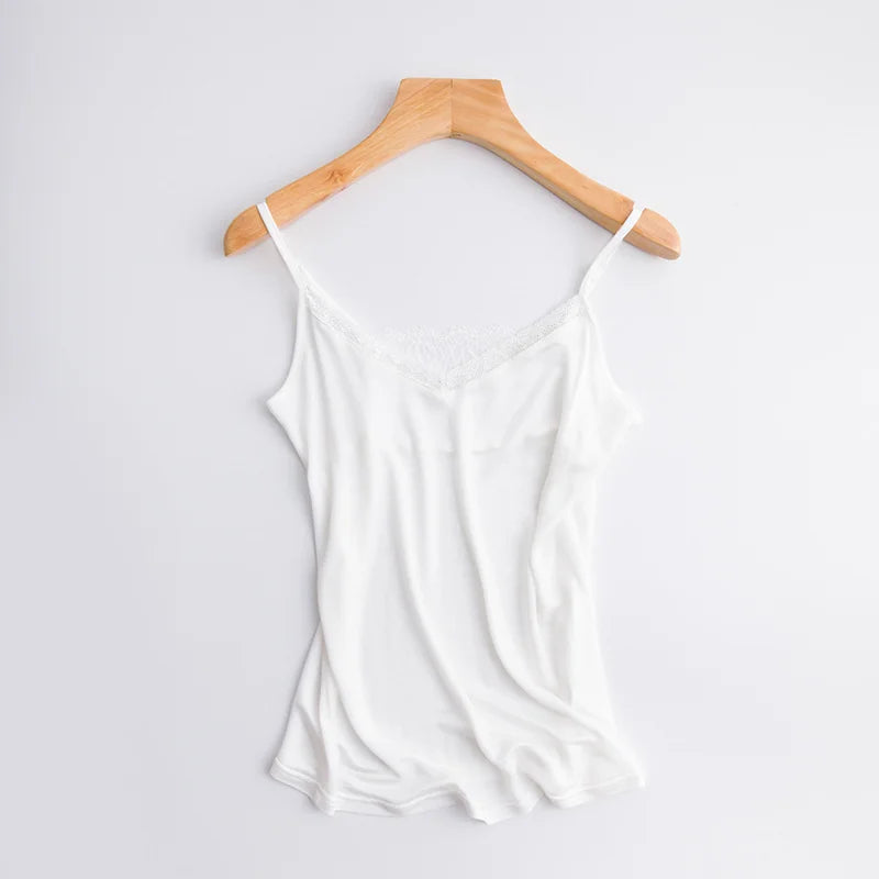 LuxeLace™ silk camisole tank top in white, sleeveless with delicate lace detail, hanging on a wooden hanger.