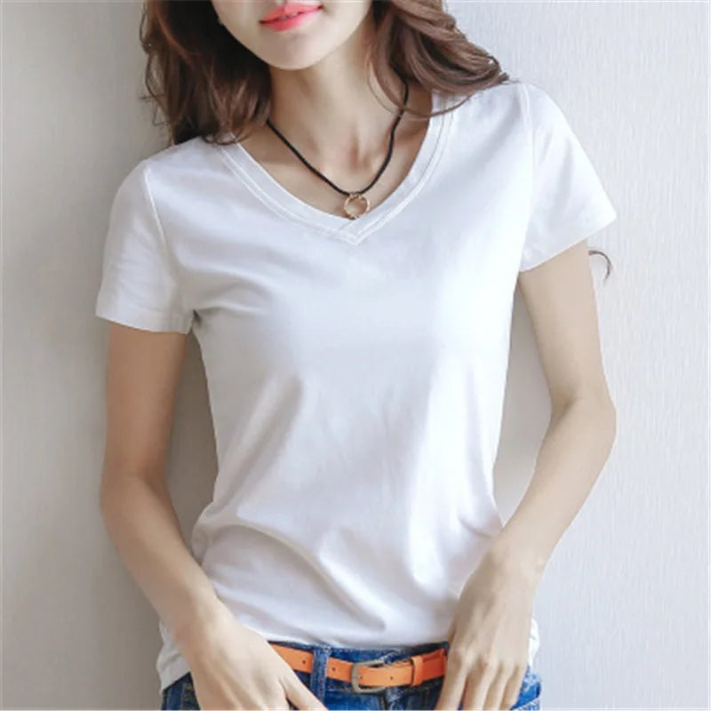 Women wearing a slim fit cotton V-neck tee in white, paired with jeans and a necklace, showcasing summer style.