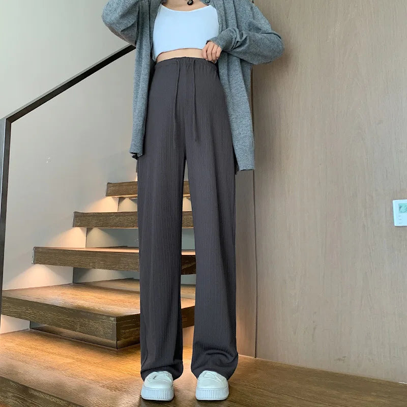 Wide-leg maternity pants with drawstring waist, styled for comfort and elegance during pregnancy.