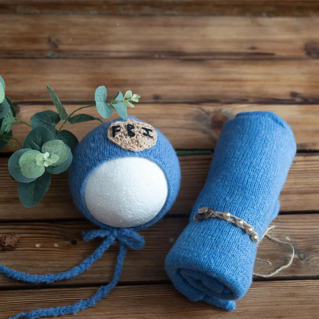 Newborn stretch knit mohair set featuring a blue knitted wrap and a decorative ball, perfect for baby photography.