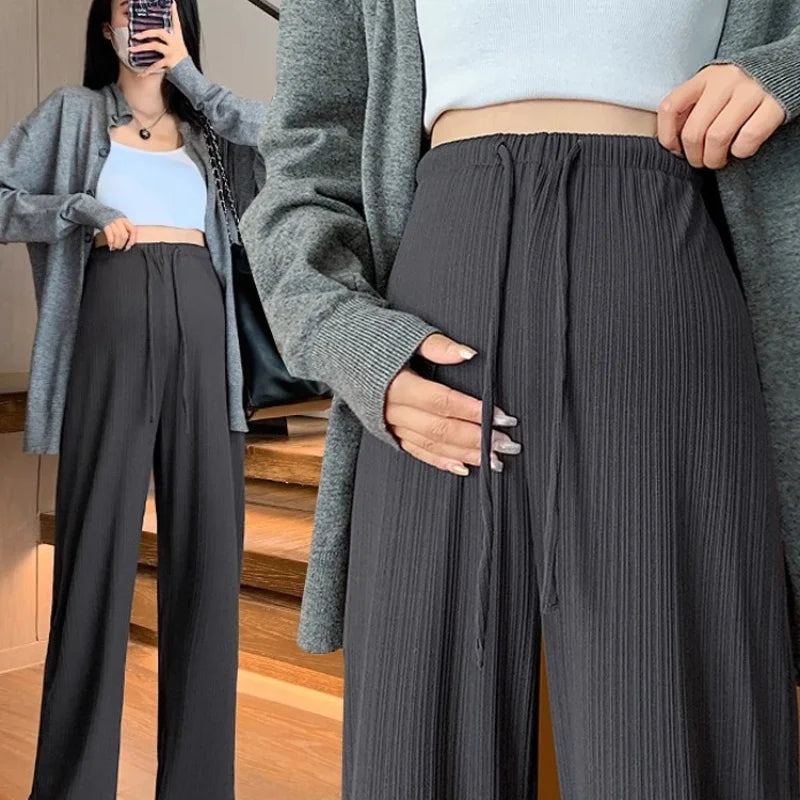 Wide-leg maternity pants with drawstring, ribbed fabric, perfect for comfort and style during pregnancy.