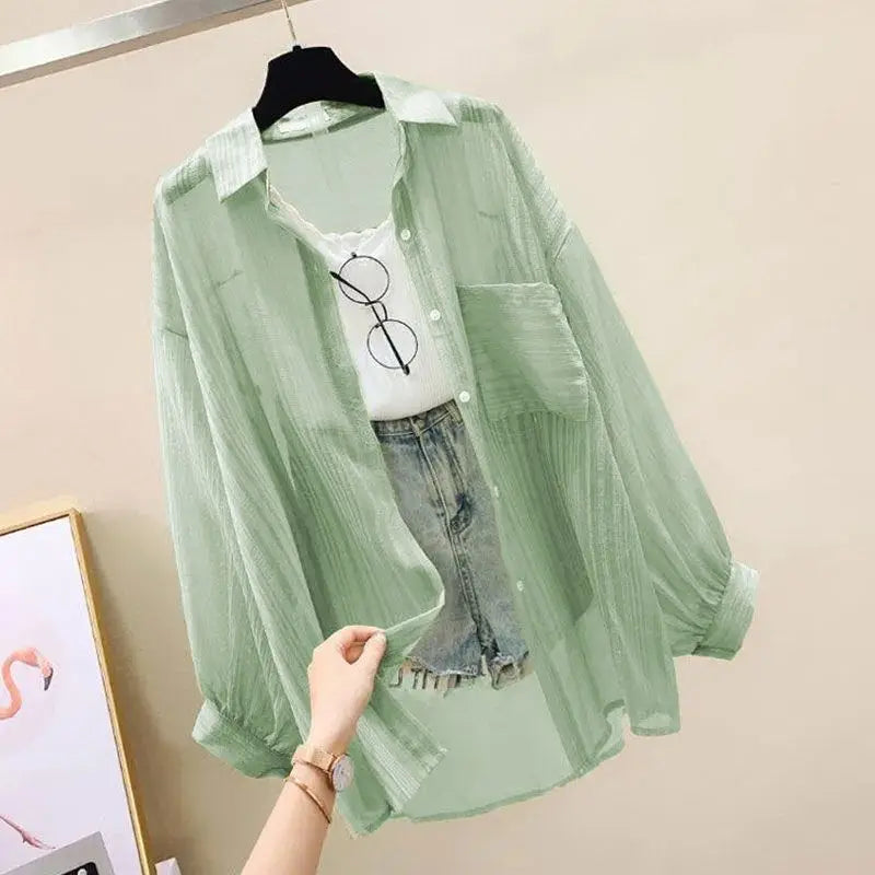 Sheer chiffon sunscreen shirt in light green, paired with a white top and denim shorts. Perfect for spring/summer casual style.