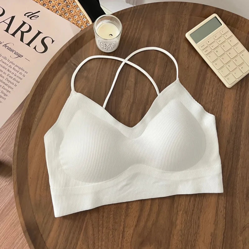 White padded backless tank top with double straps on a wooden surface, perfect for summer wear.