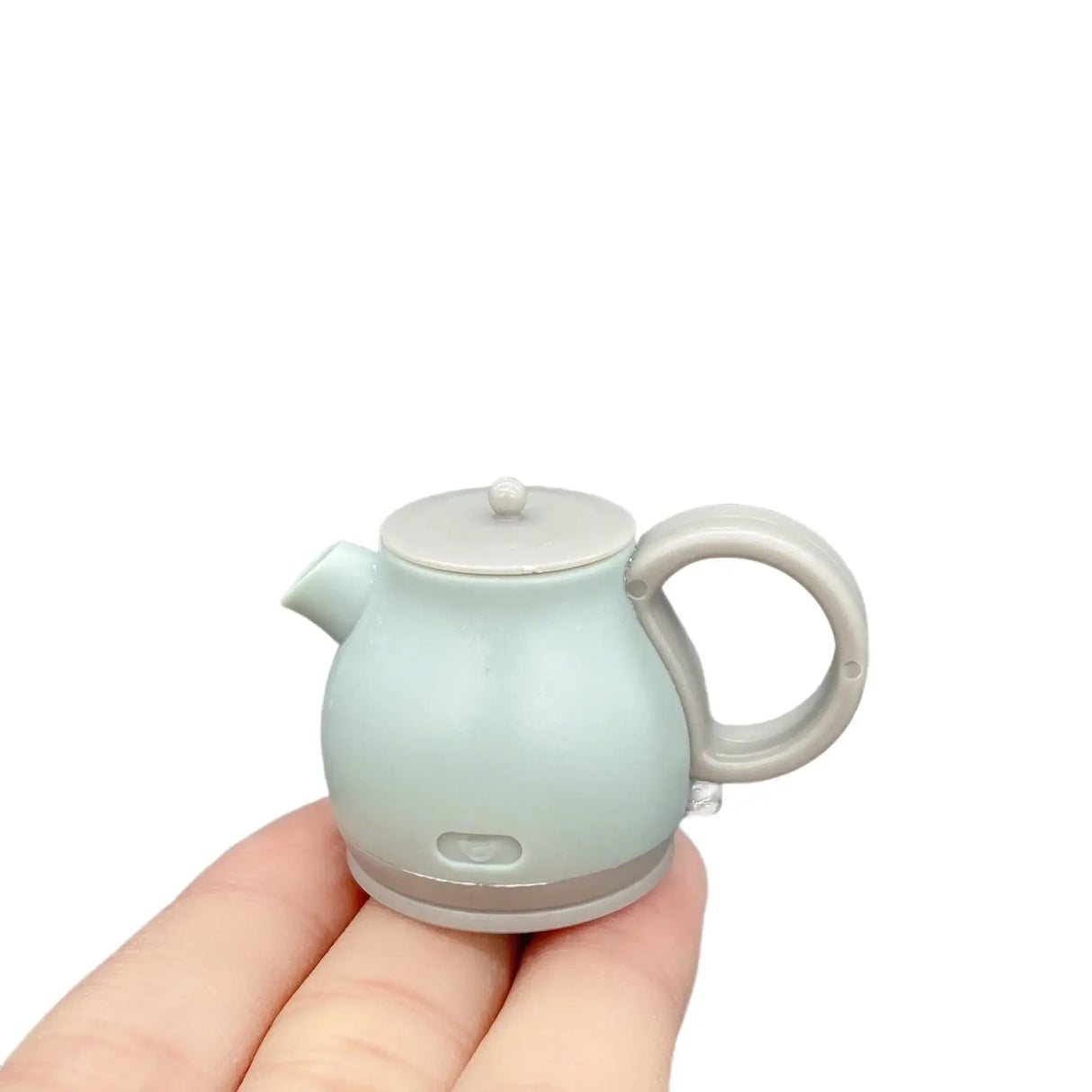 Mini resin baby photography prop in the shape of a light blue kettle, perfect for newborn photoshoots.